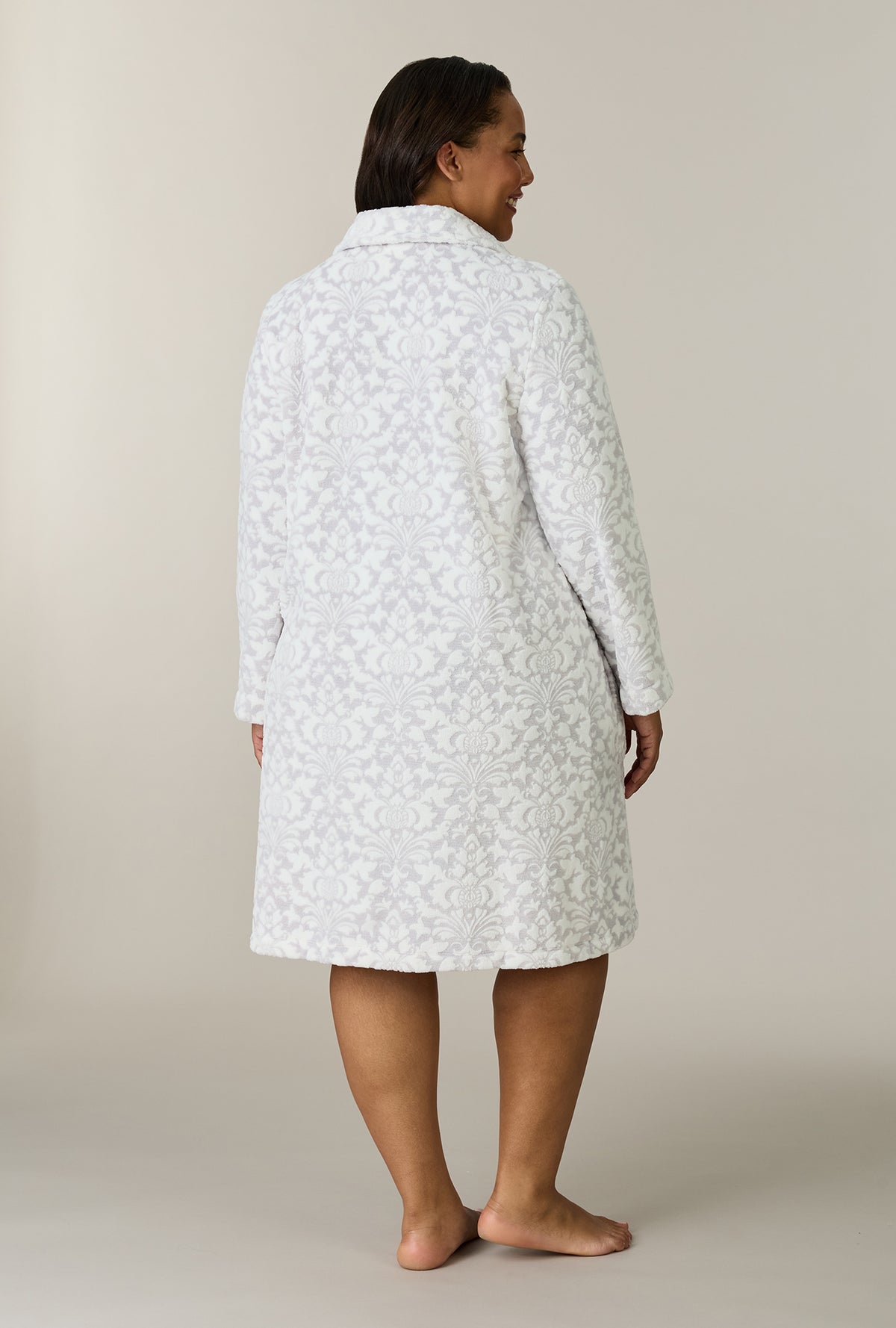 A lady wearing plus size Pearl Damask Two-Tone Velour Short Zip Robe back view