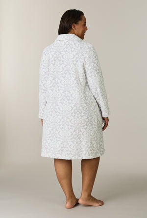 A lady wearing plus size Pearl Damask Two-Tone Velour Short Zip Robe back view
