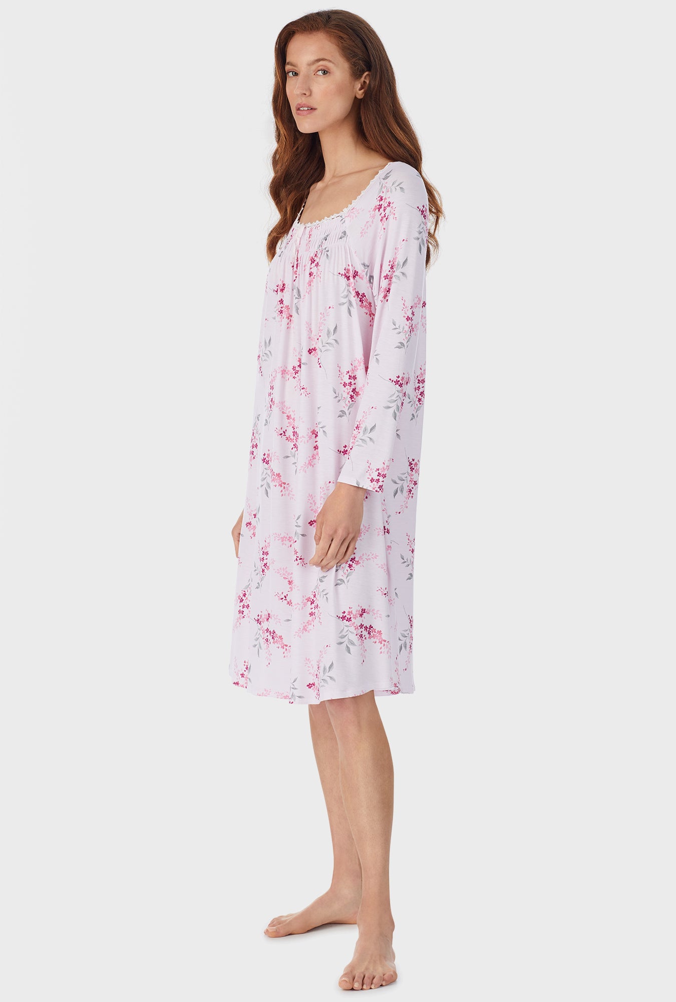 A lady wearing white waltz nightgown with pink floral print