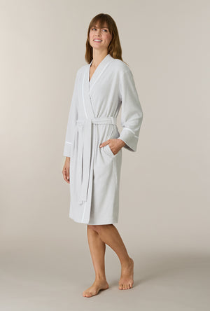 A lady wearing Lunar Rock Terry Wrap Waltz Robe looking up