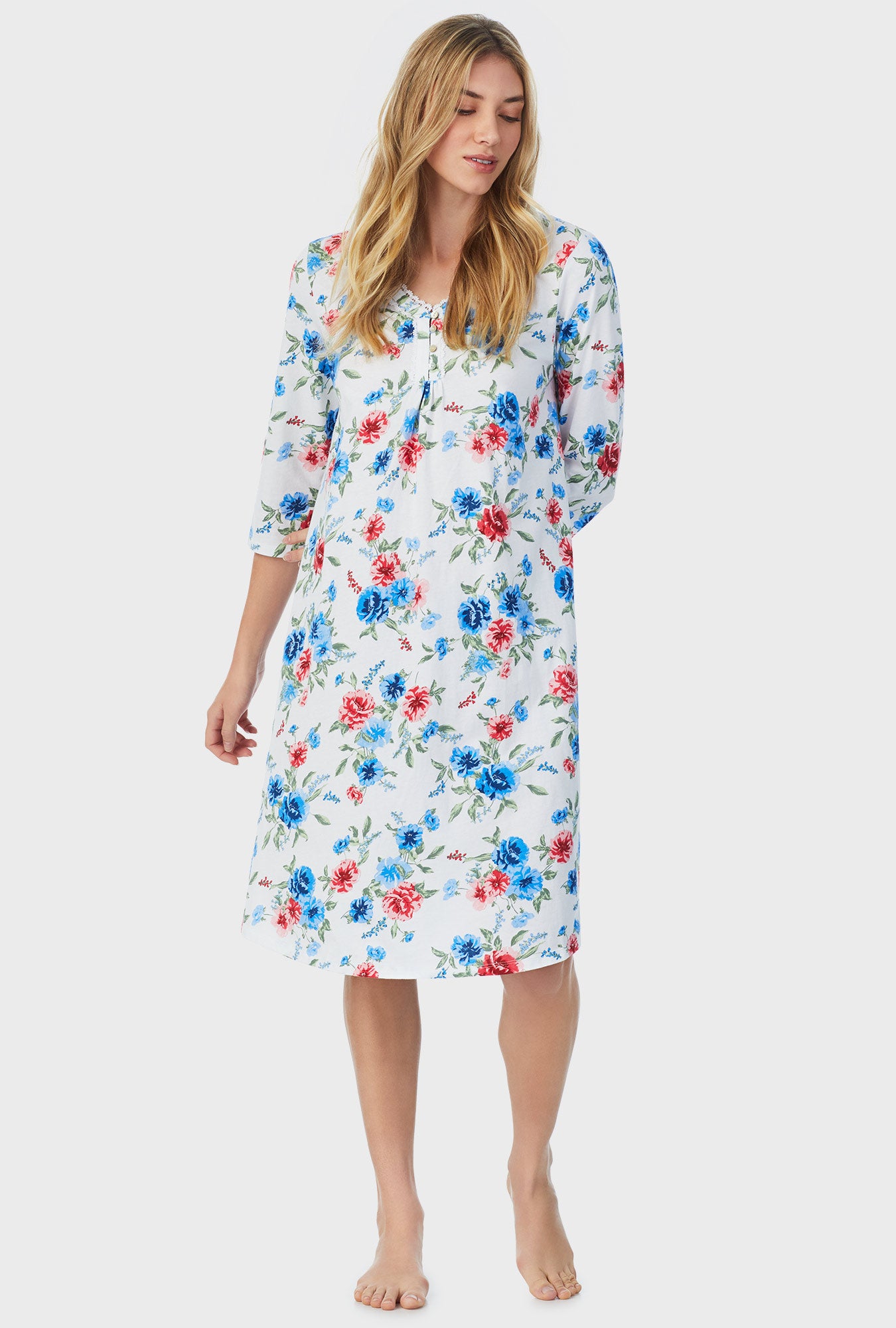 A lady wearing white quarter sleeve waltz nightgown with icy floral print.