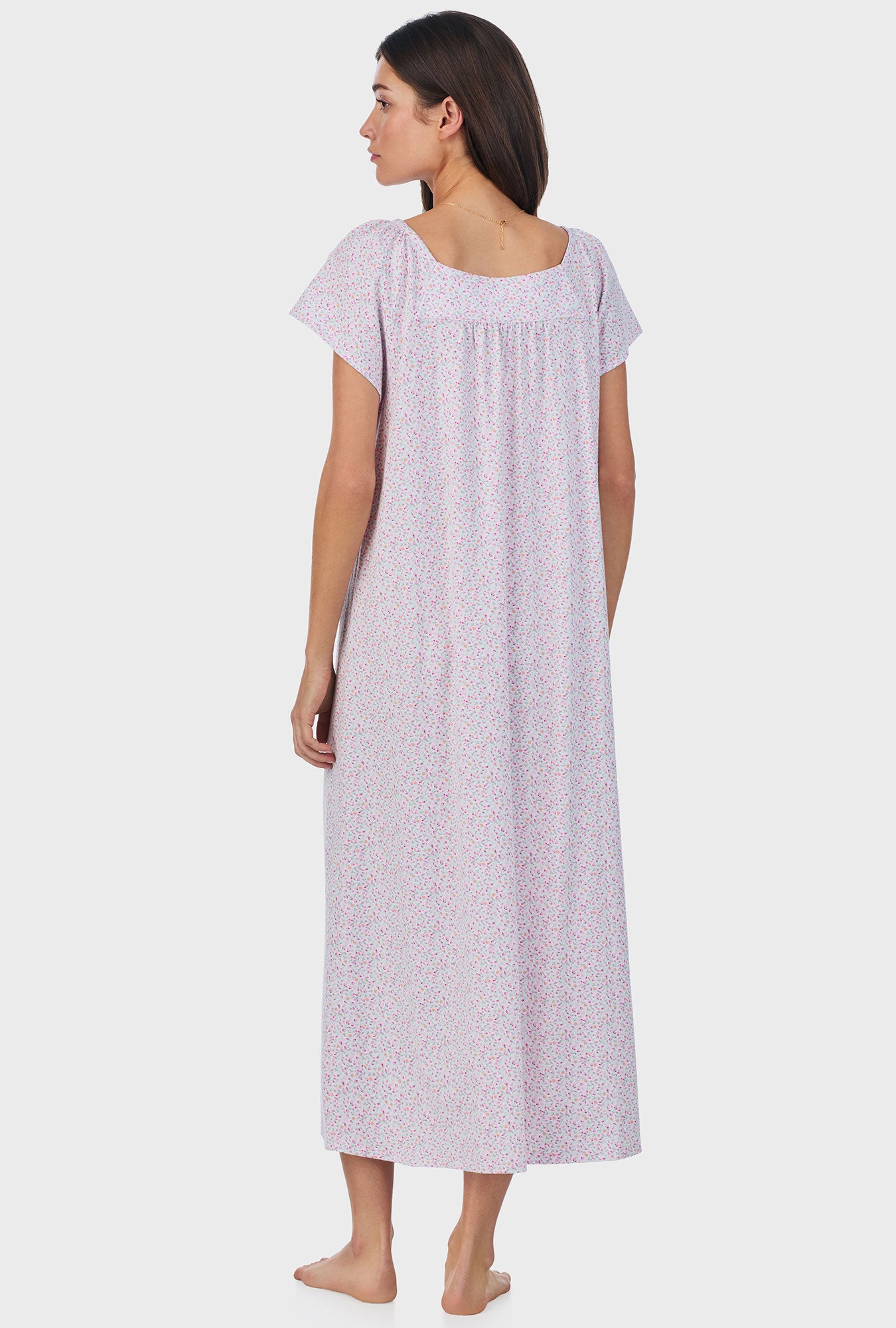 A lady wearing pink short sleeve cotton ballet nightgown with tulip field print.