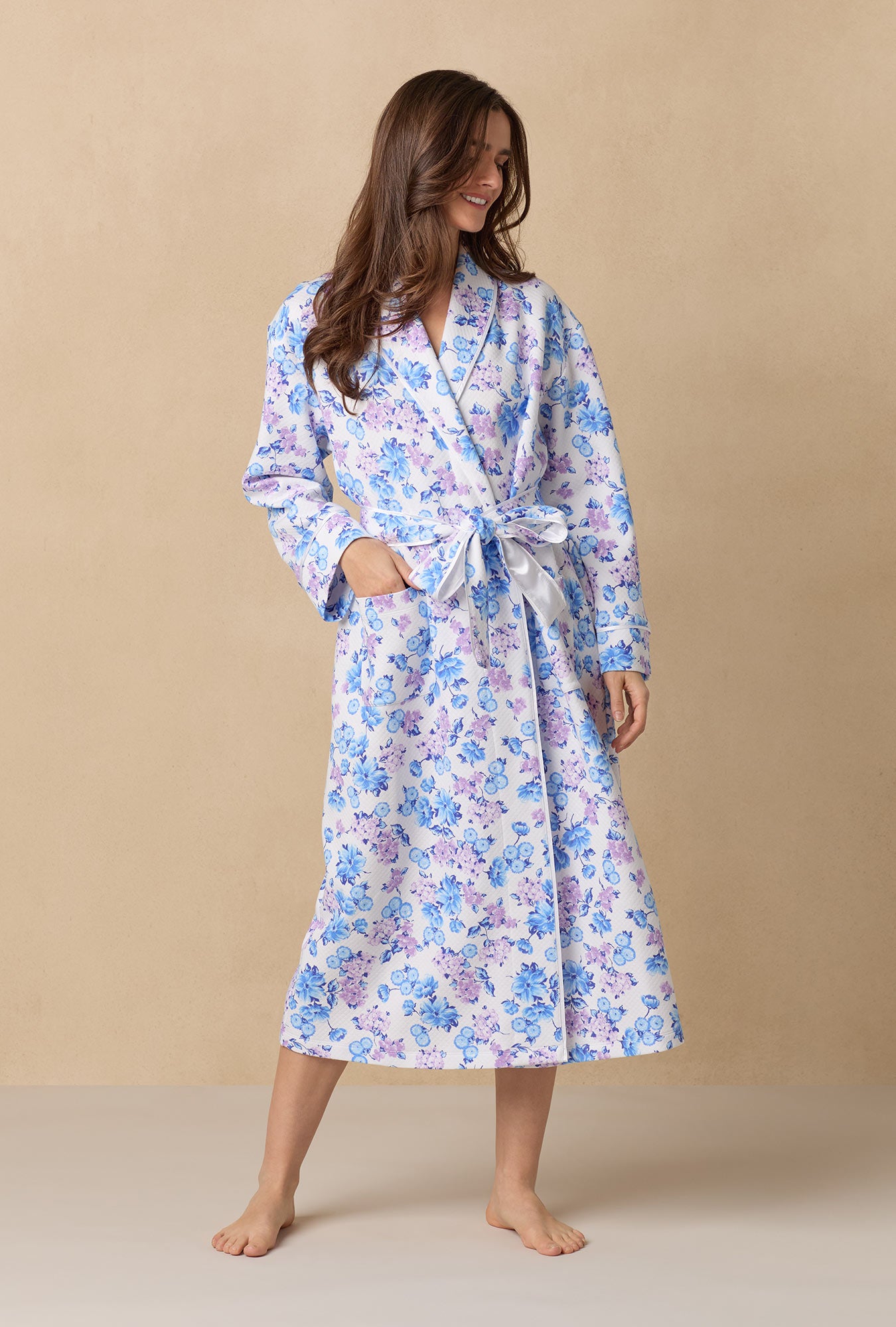 Purple Hydrangea; Missy Model is wearing Size Small. She is 5'10", Bust 32", Waist 24", Hips 35"@A lady wearing Purple Hydrangea 
long sleeve diamond quilted wrap robe.