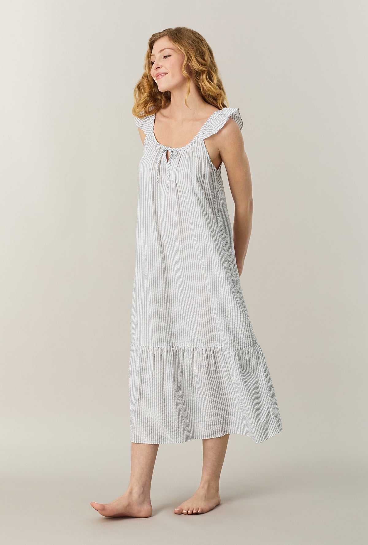 A lady wearing Grey Stripe Seersucker Midi Chemise looking side