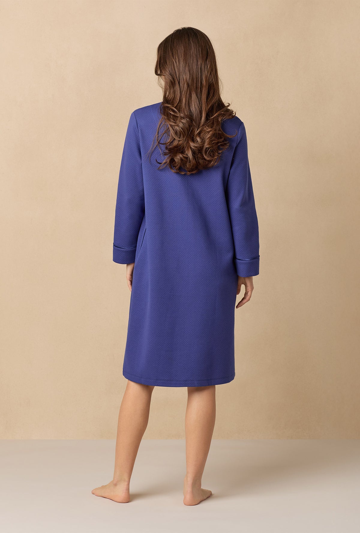 A lady wearing Navy Diamond Quilted Zip Robe
