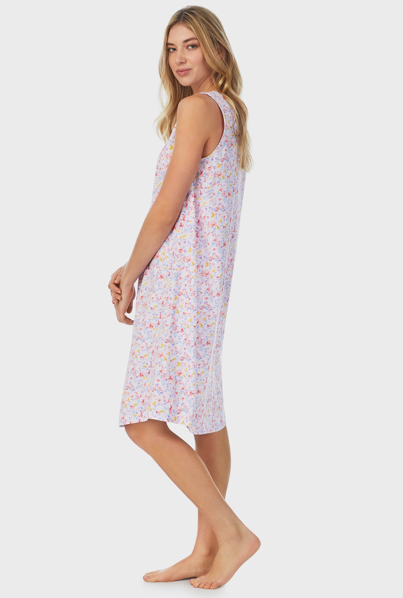 A lady wearing white sleeveless Waltz Nightgown with Garden Floral print