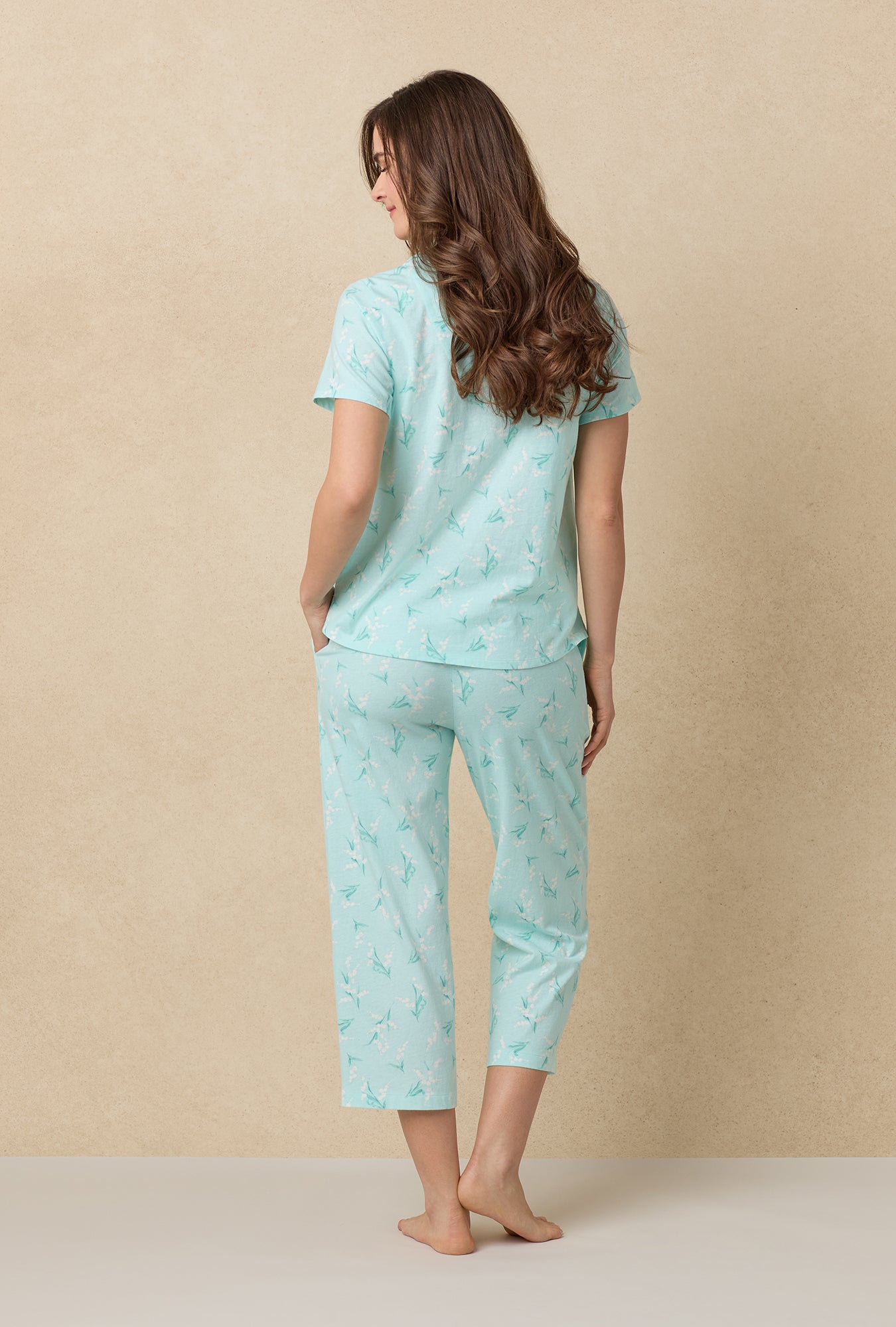 A lady wearing Lily Of The Valley Cotton Capri Pajama Set