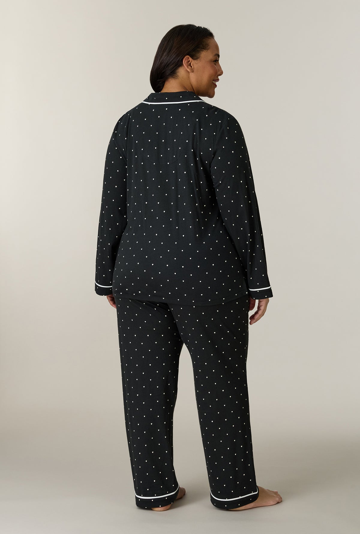 A lady wearing plus size Midnight Hearts Cotton Notch Collar Long Pajama Set back view