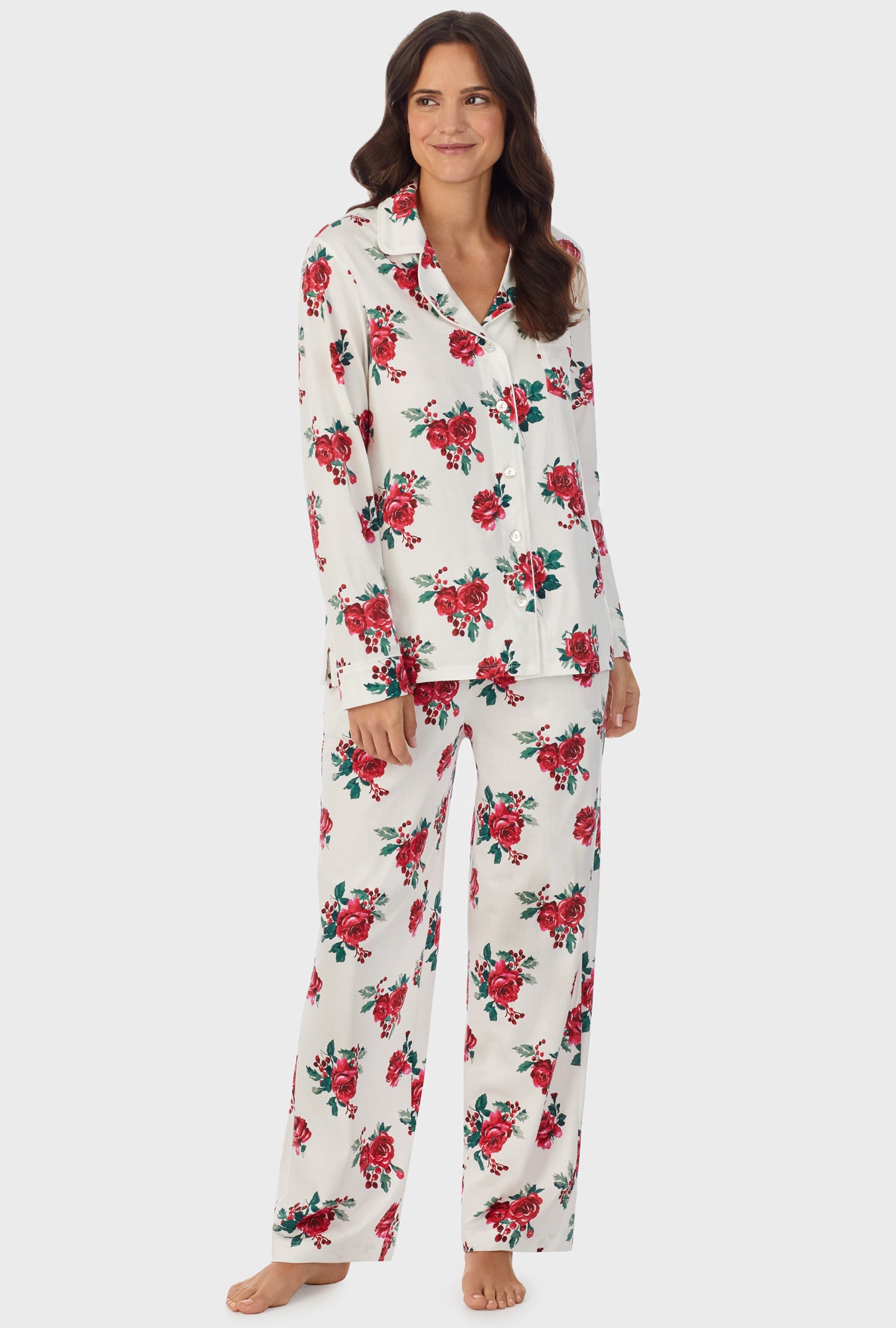 A lady wearing white long pajama set with red rose print