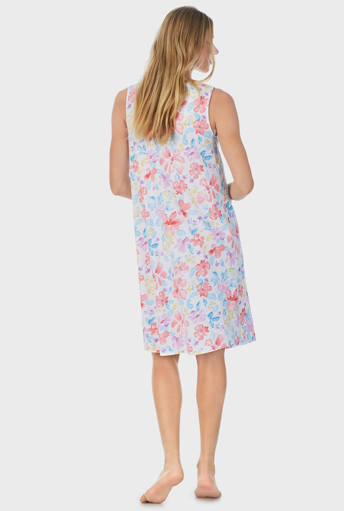 A lady wearing white Waltz Nightgown with Tropical Blooms print