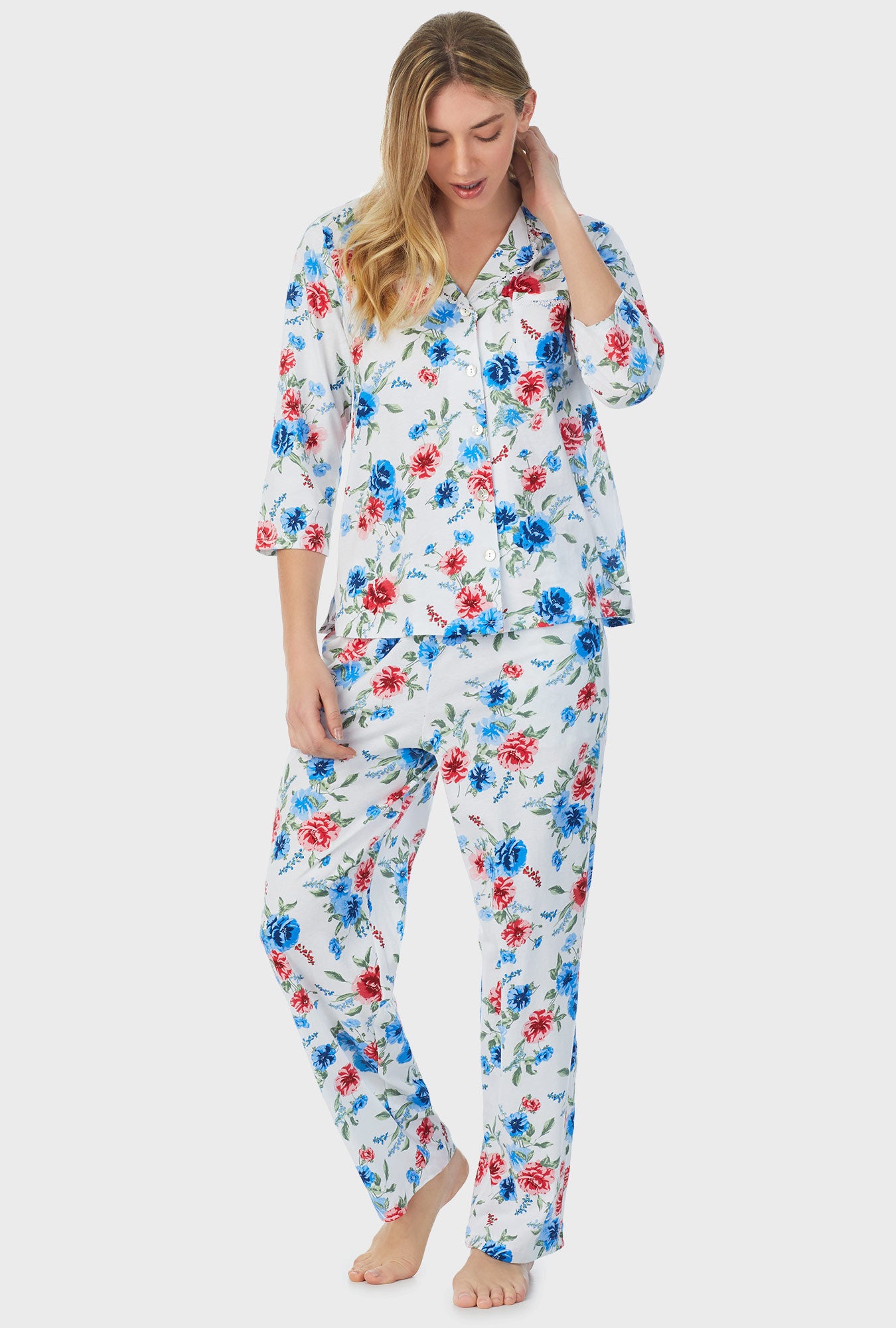 A lady wearing white quarter sleeve long pajama set with icy floral print.