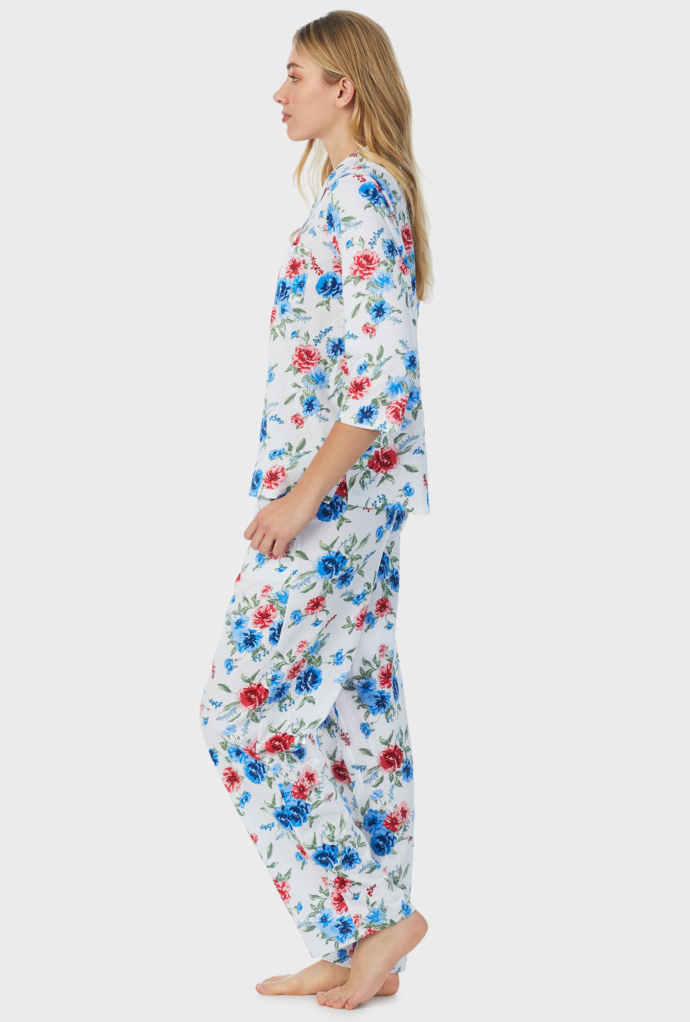 A lady wearing white quarter sleeve long pajama set with icy floral print.