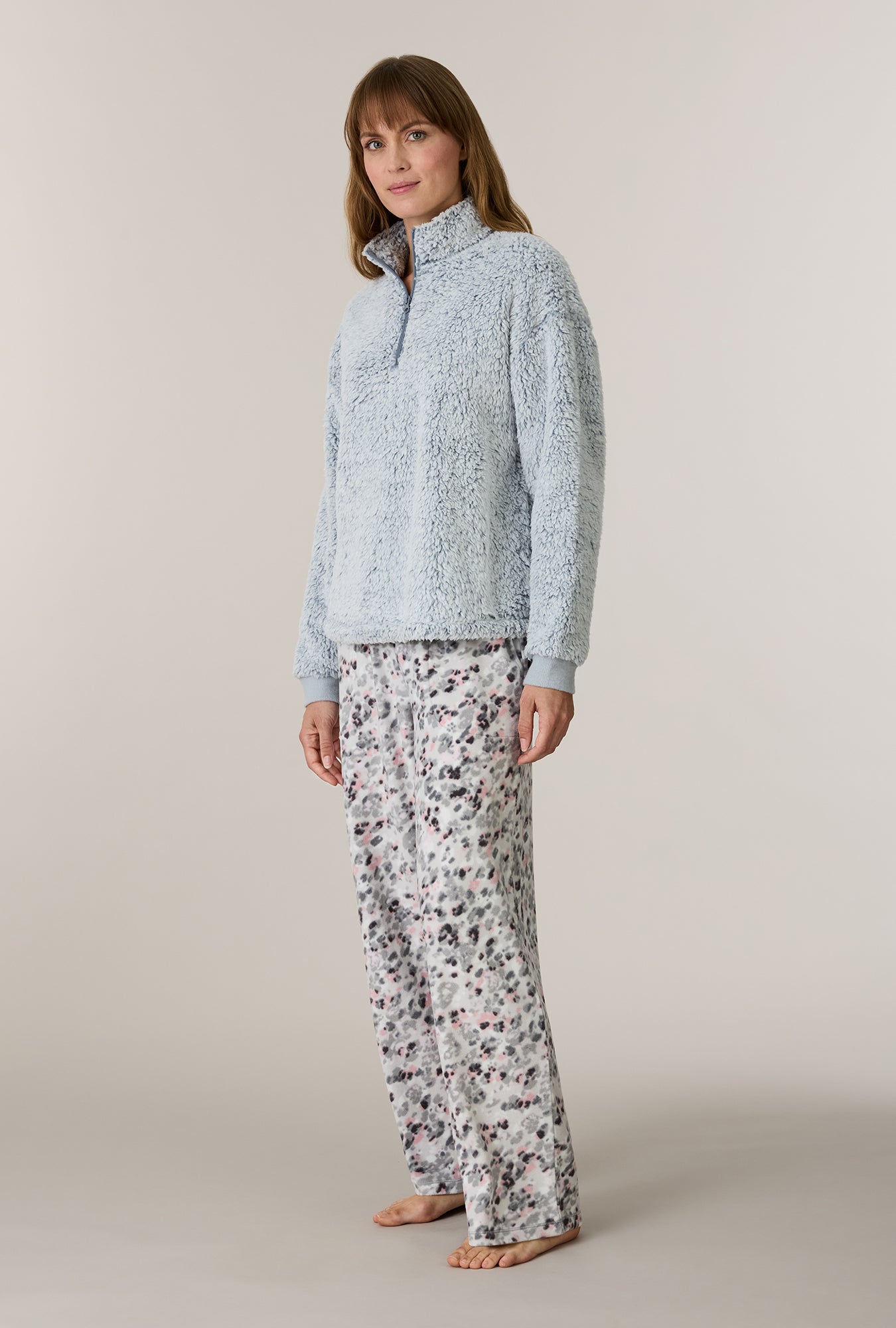 A lady wearing Soft Leopard Sherpa Zip Top & Stretch Fleece Pajama Set looking side