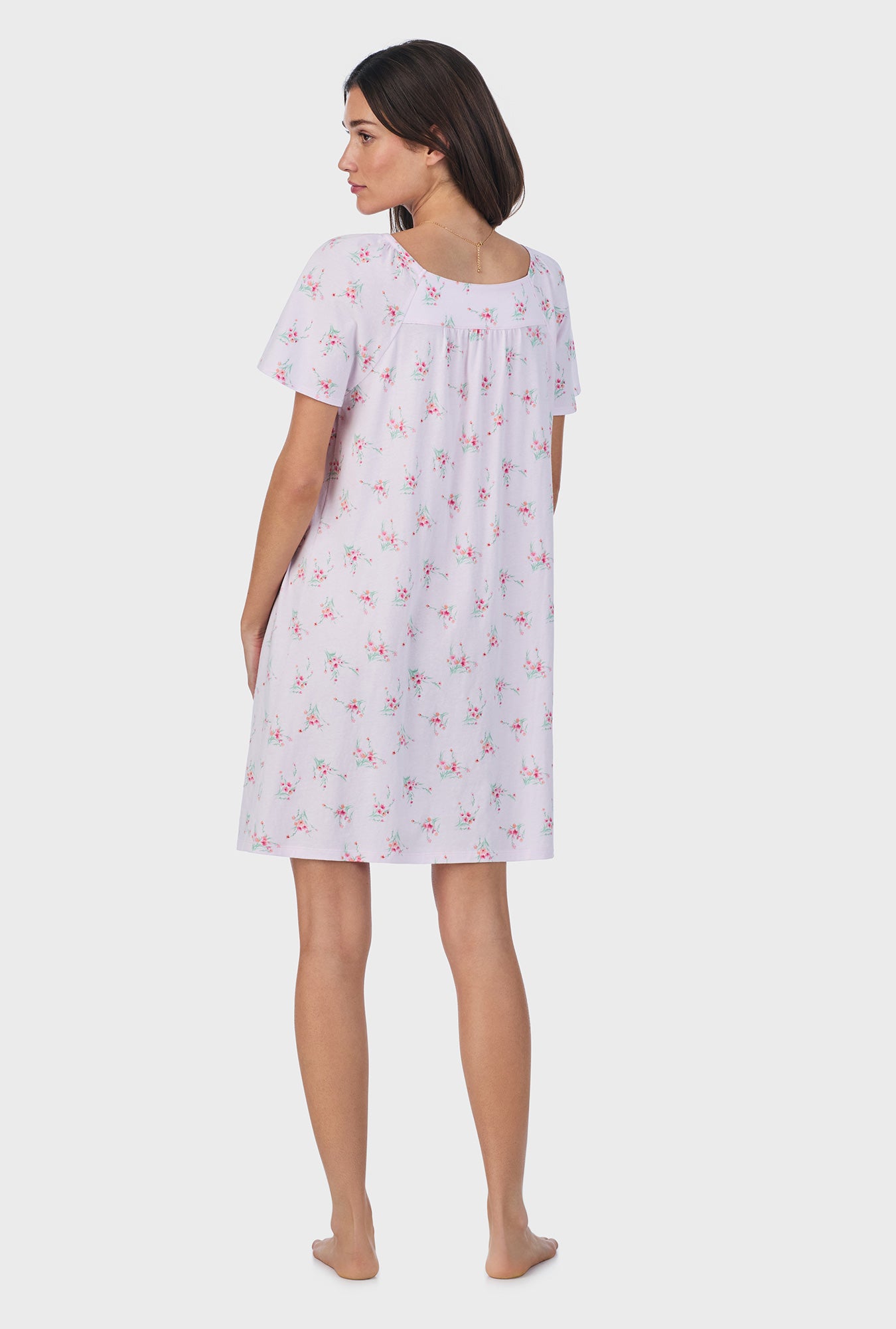 A lady wearing pink short sleeve cotton short nightgown with sweet blooms print.
