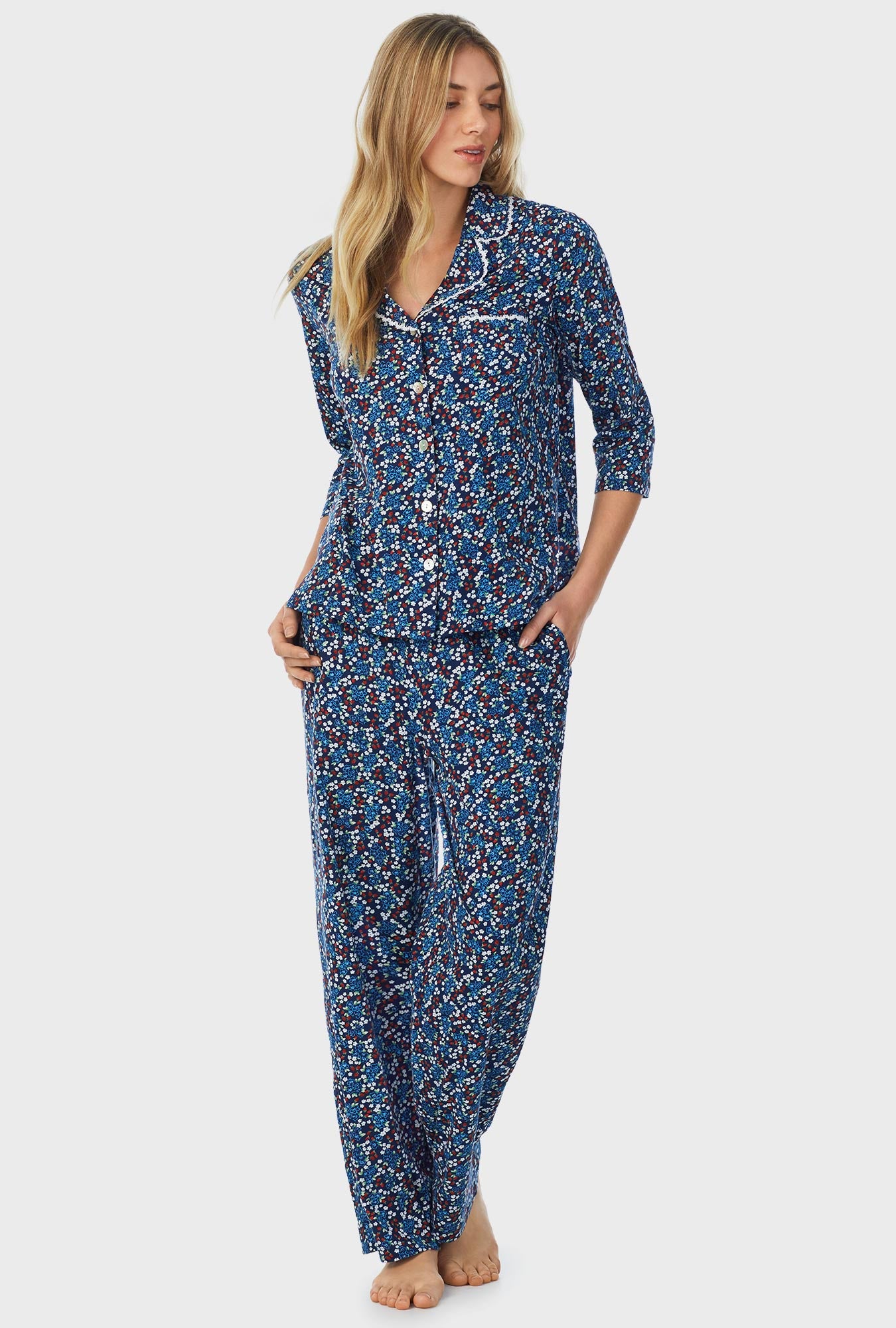 A lady wearing blue quarter sleeve long pajama set with moonlight print.