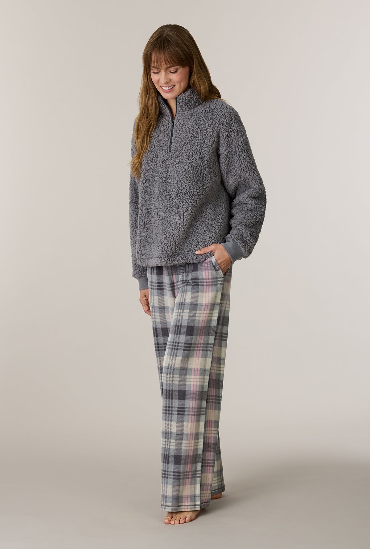 A lady wearing Charcoal Plaid Sherpa Zip Top & Stretch Fleece Pajama Set looking down