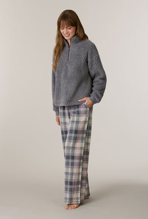 A lady wearing Charcoal Plaid Sherpa Zip Top & Stretch Fleece Pajama Set looking down