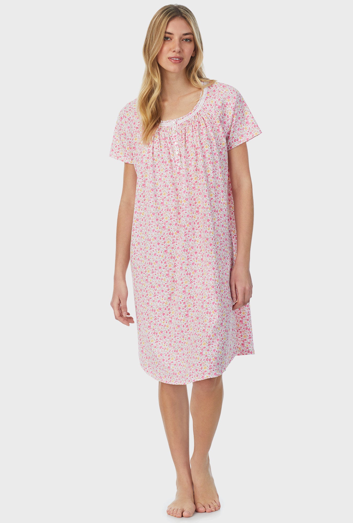A lady wearing pink short sleeve waltz nightgown with spring  ditsy.