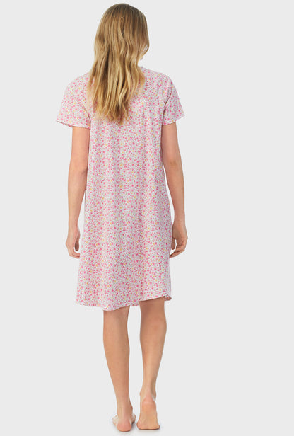 A lady wearing pink short sleeve waltz nightgown with spring  ditsy.