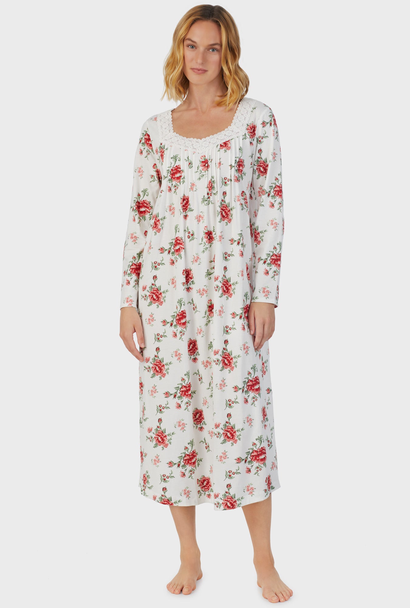 A lady wearing white long sleeve long royal garden nightgown.