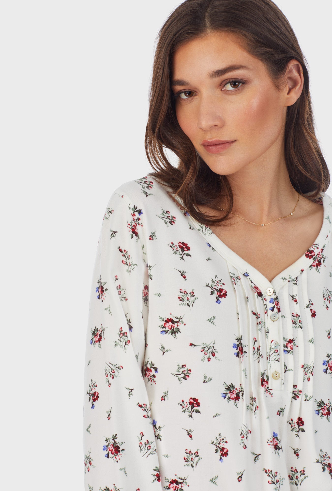 A lady wearing white long sleeve cotton rayon flannel waltz wild flower nightgown.