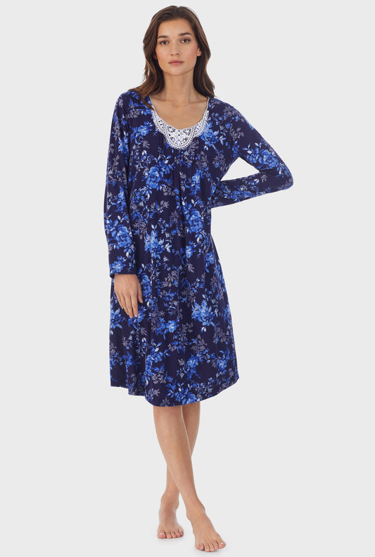 A lady wearing navy long sleeve cotton waltz nightgown with navy floral print.