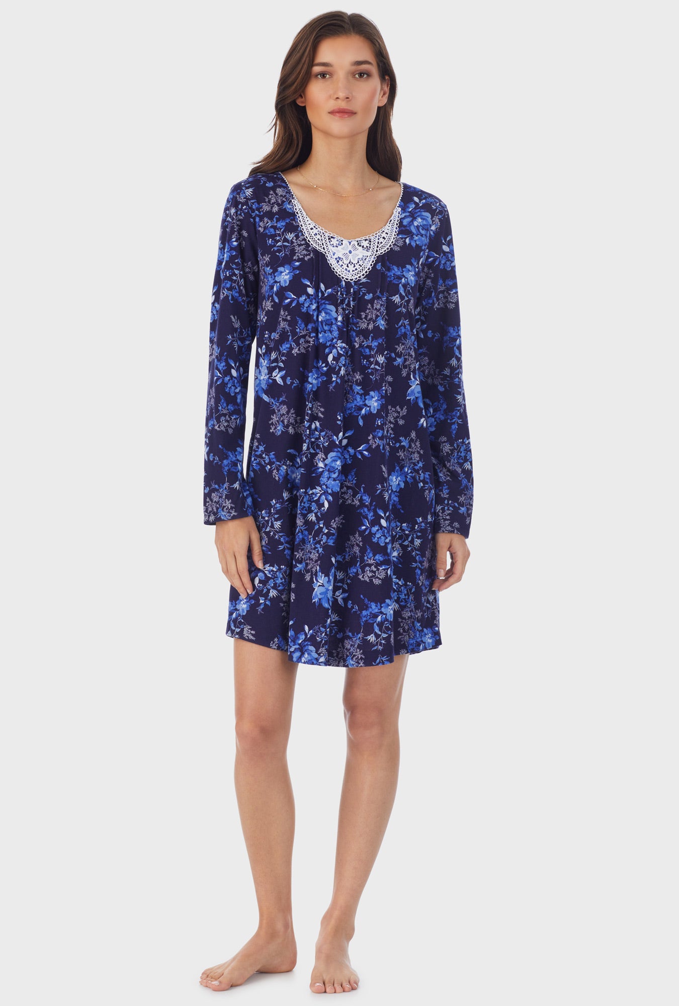 A lady wearing navy long sleeve cotton short nightgown with navy floral print.