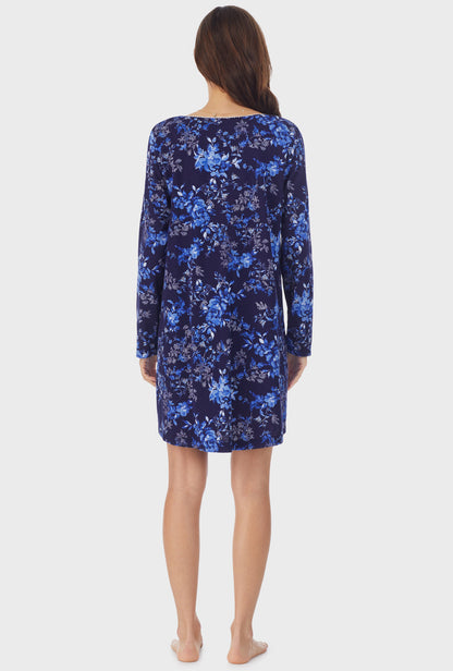 A lady wearing navy long sleeve cotton short nightgown with navy floral print.