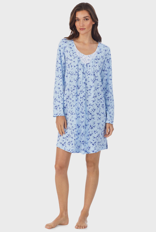A lady wearing blue long sleeve cotton short nightgown with winter floral print.