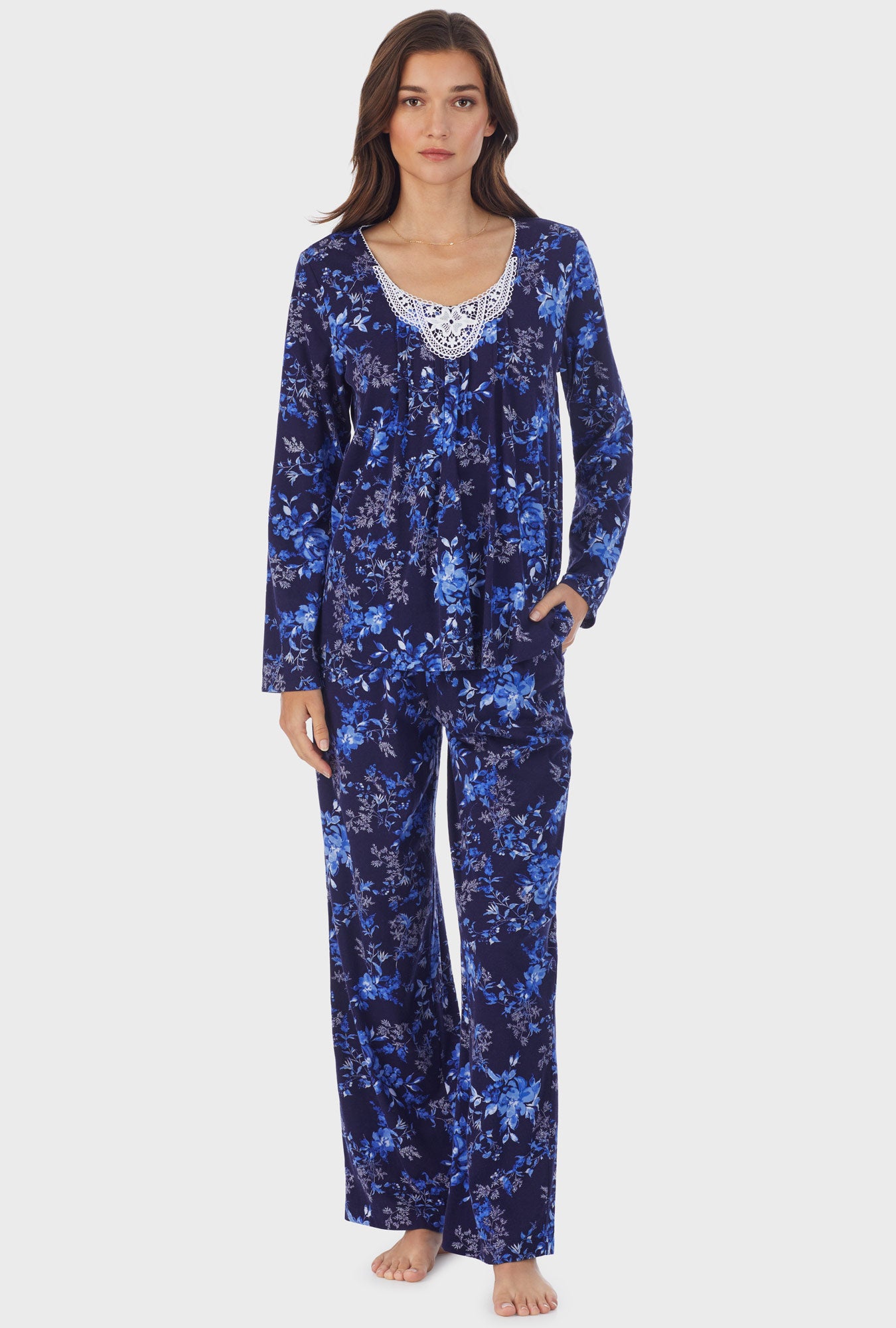 A lady wearing long sleeve cotton long pajama set with navy floral print.