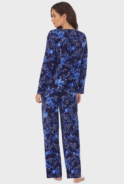 A lady wearing long sleeve cotton long pajama set with navy floral print.