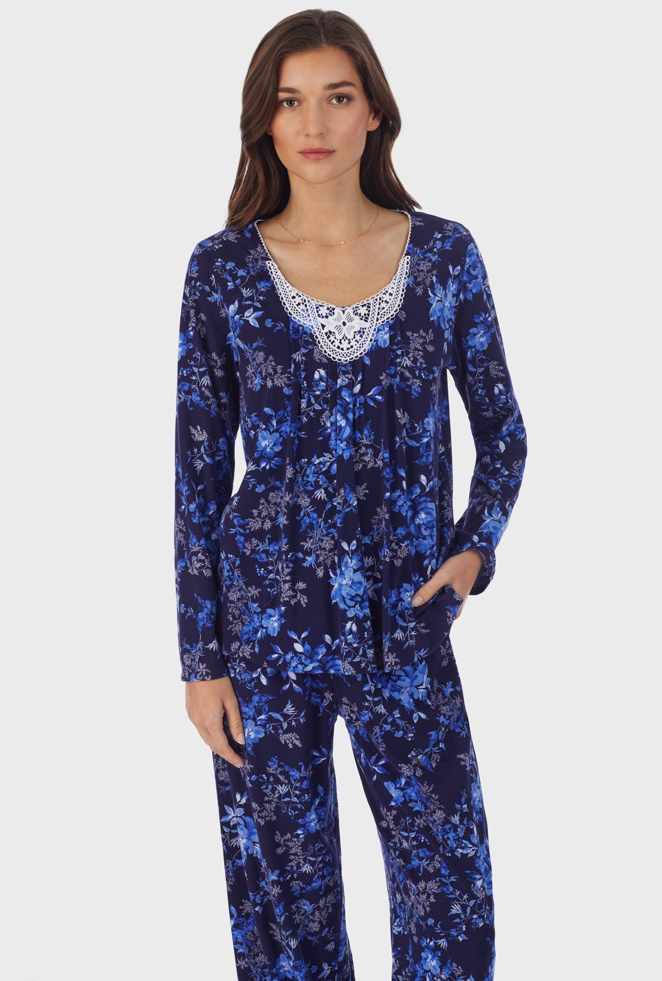 A lady wearing long sleeve cotton long pajama set with navy floral print.