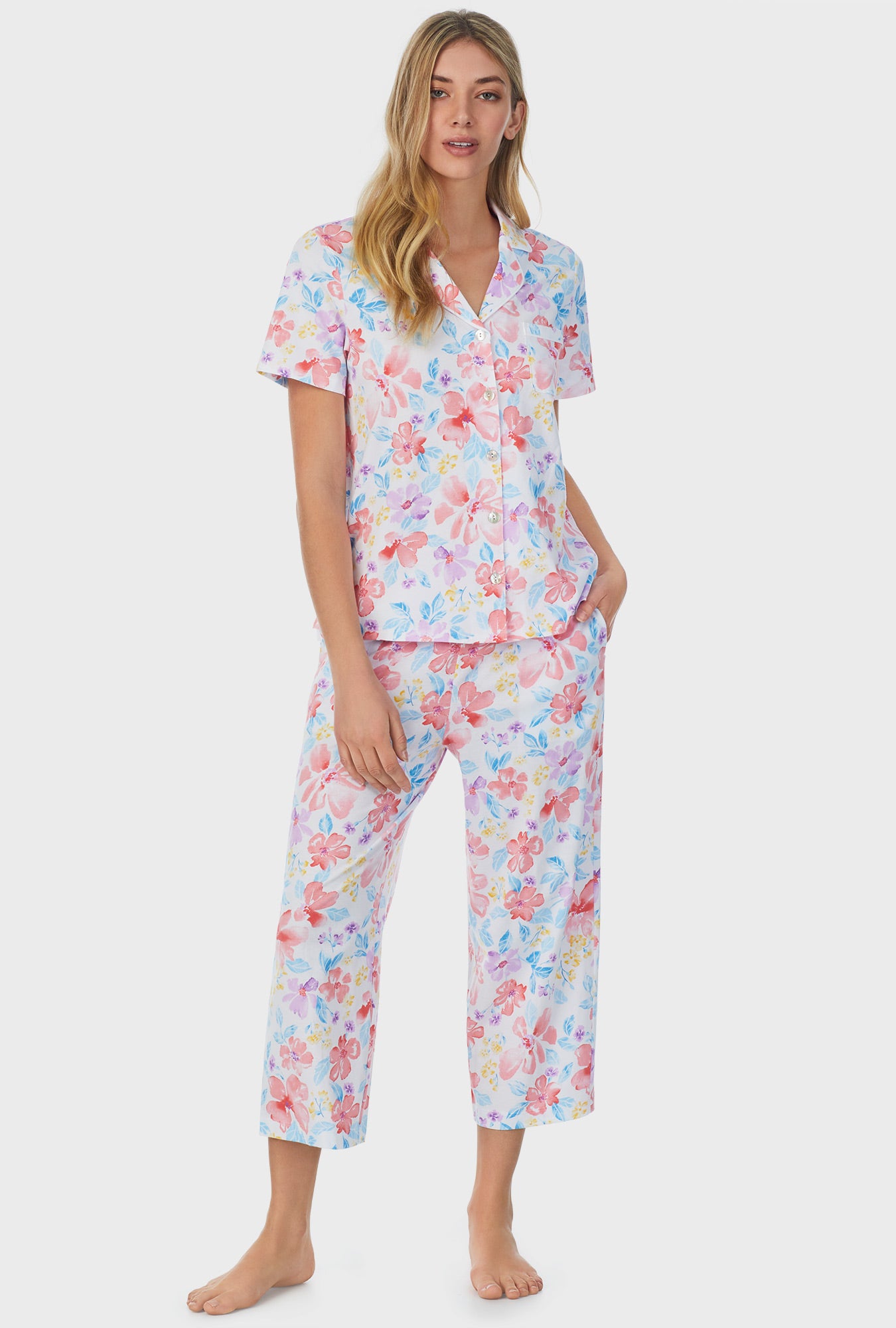 A lady wearing white short sleeve Capri Pajama Set with Tropical Blooms print