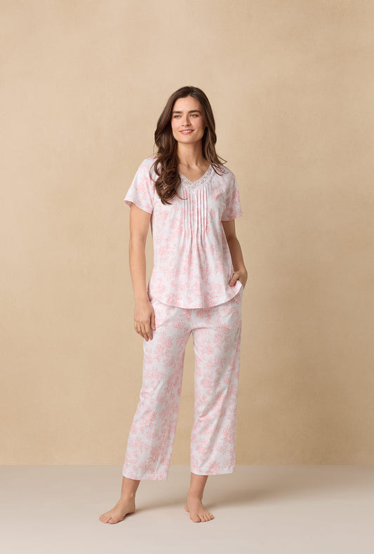 A lady wearing Coral Toile Capri Cotton Knit Pajama Set