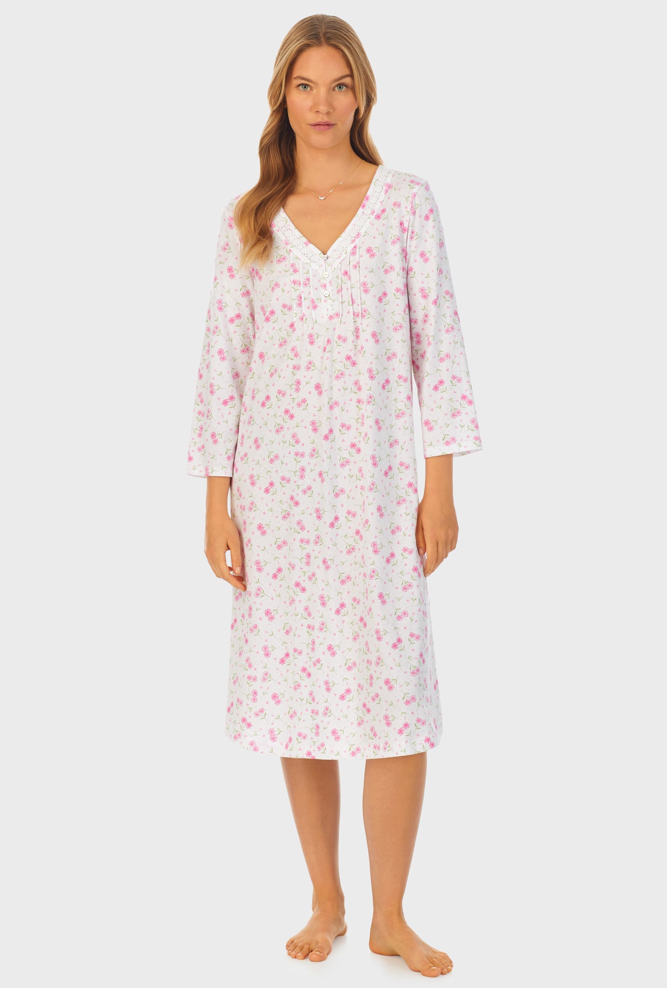 A lady wearing white quarter sleeve cotton waltz nightgown with blooming heart print.