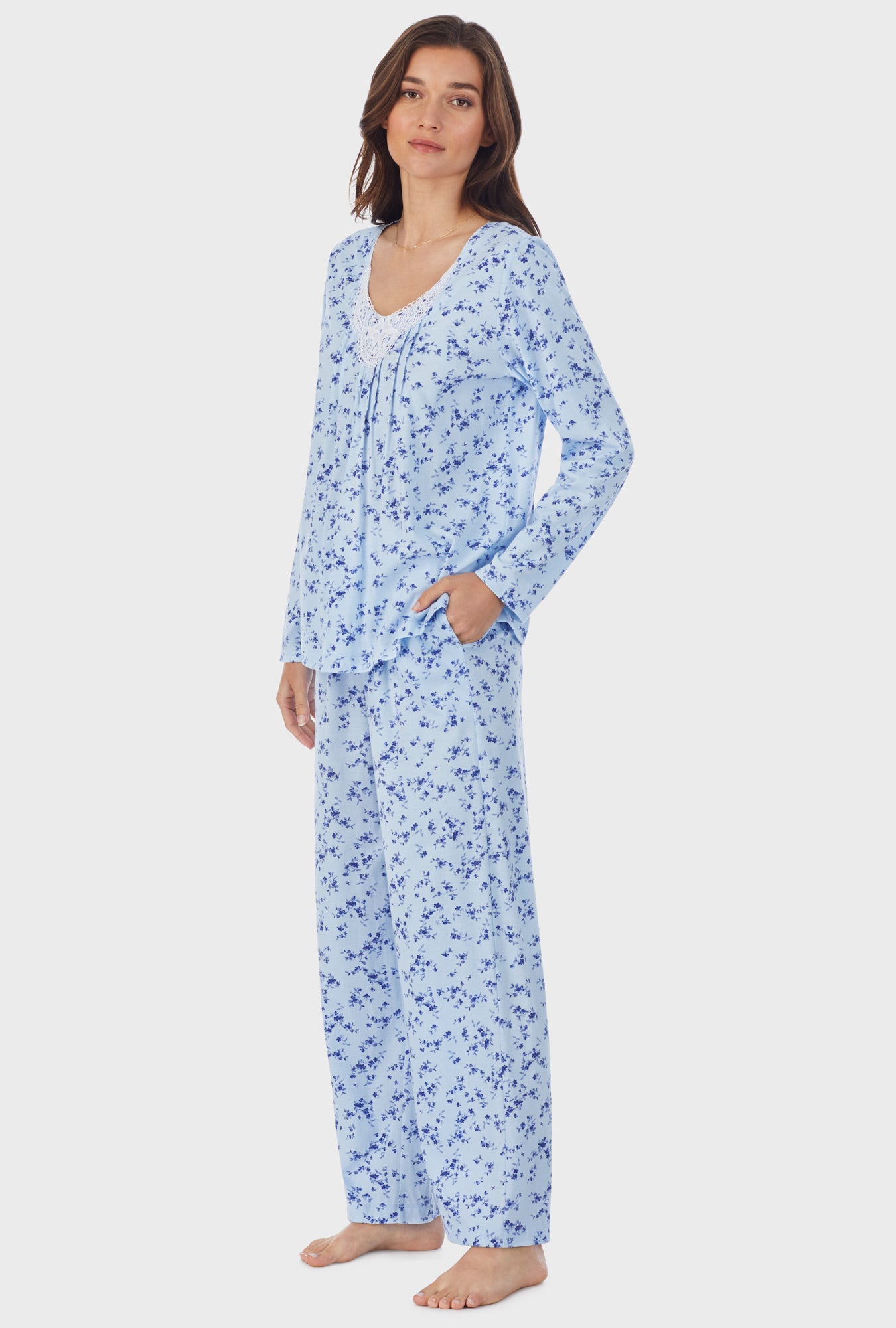 A lady wearing blue long sleeve cotton long pajama set with winter floral print.