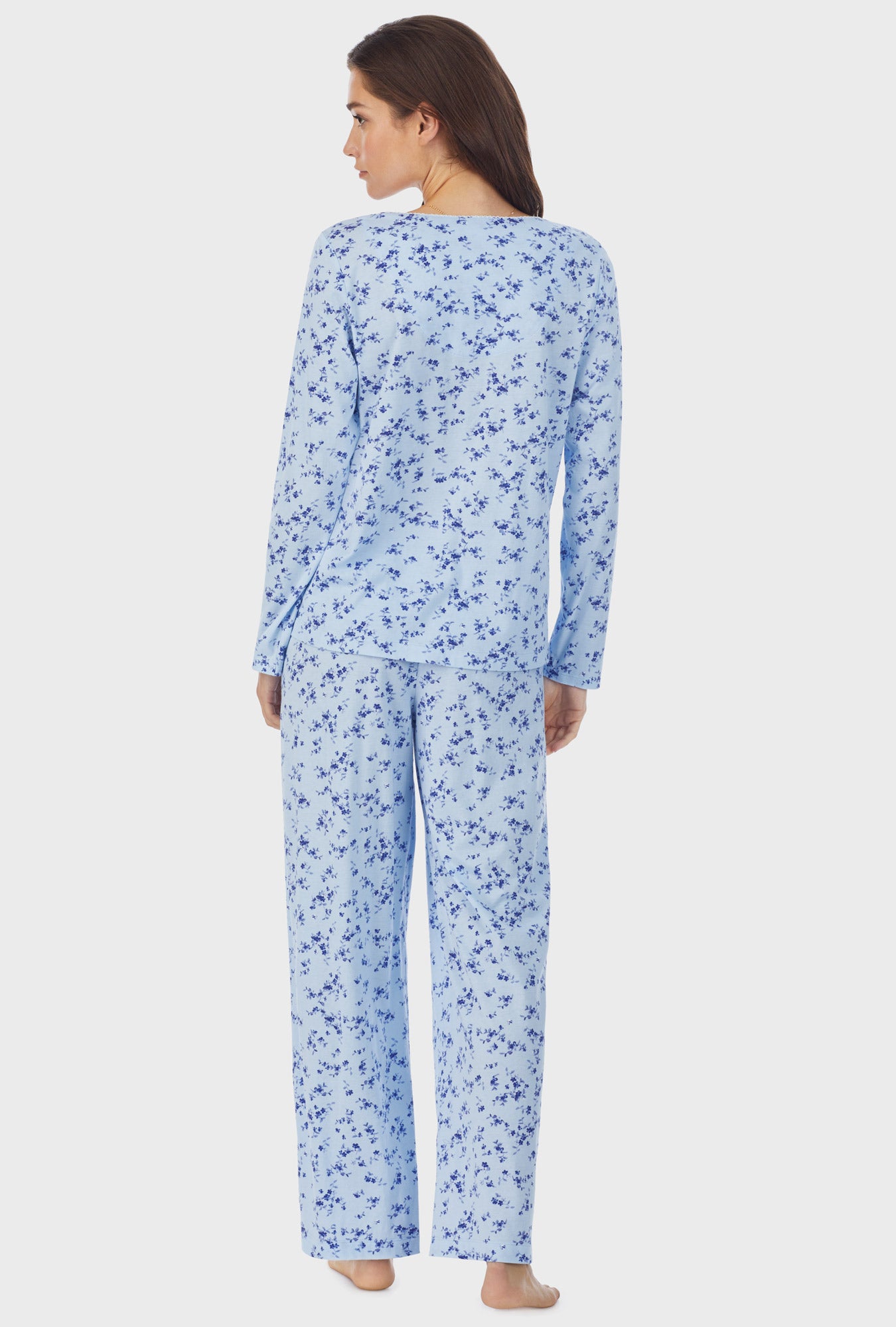 A lady wearing blue long sleeve cotton long pajama set with winter floral print.