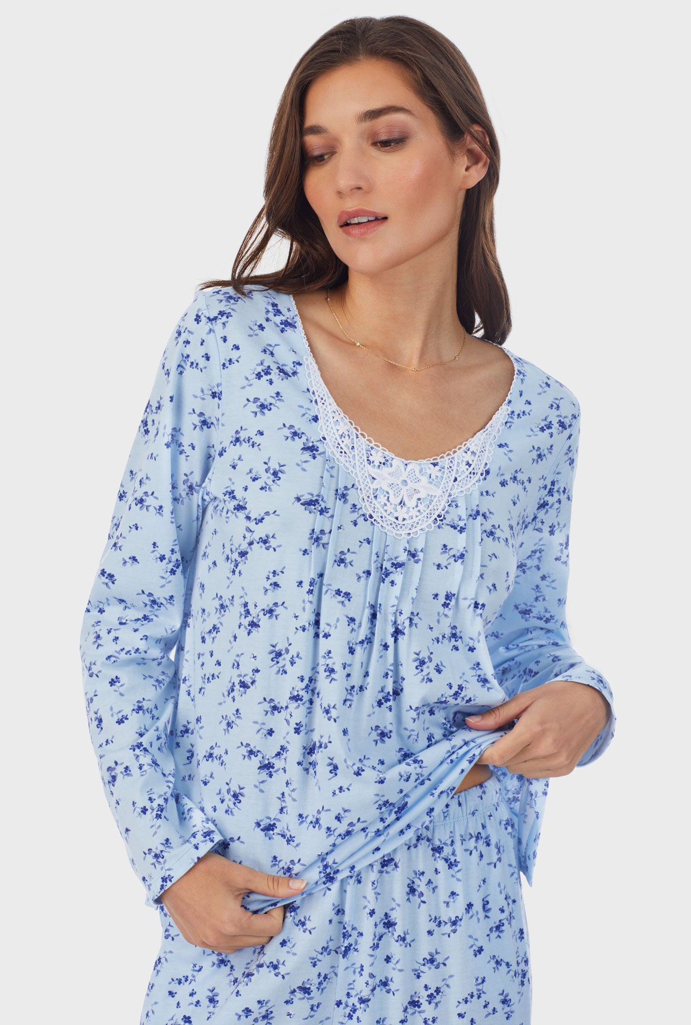 A lady wearing blue long sleeve cotton long pajama set with winter floral print.