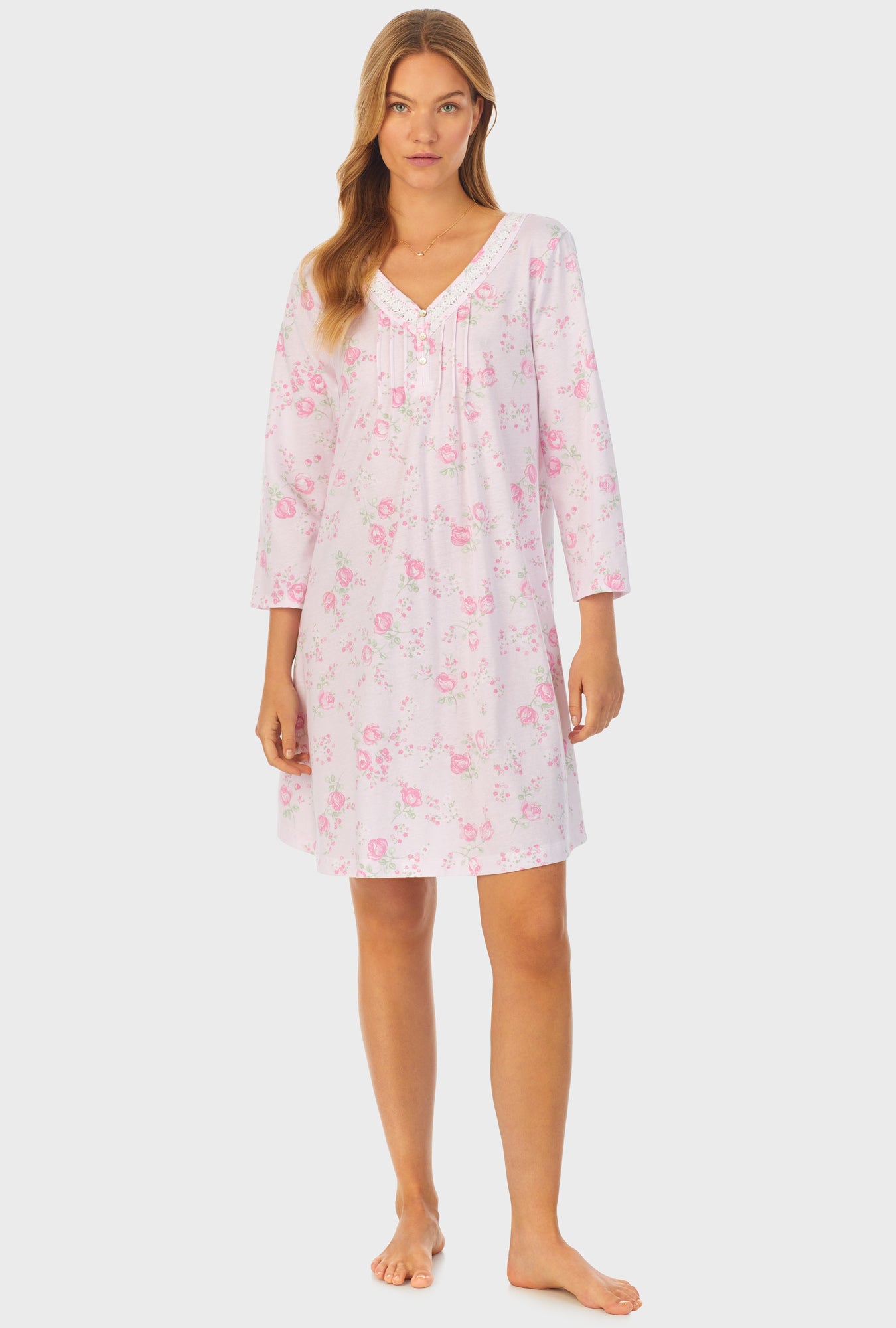 A lady wearing pink quarter sleeve cotton short nightgown with sweet rose print.