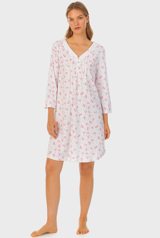 A lady wearing white quarter sleeve cotton short nightgown with blooming hearts print.