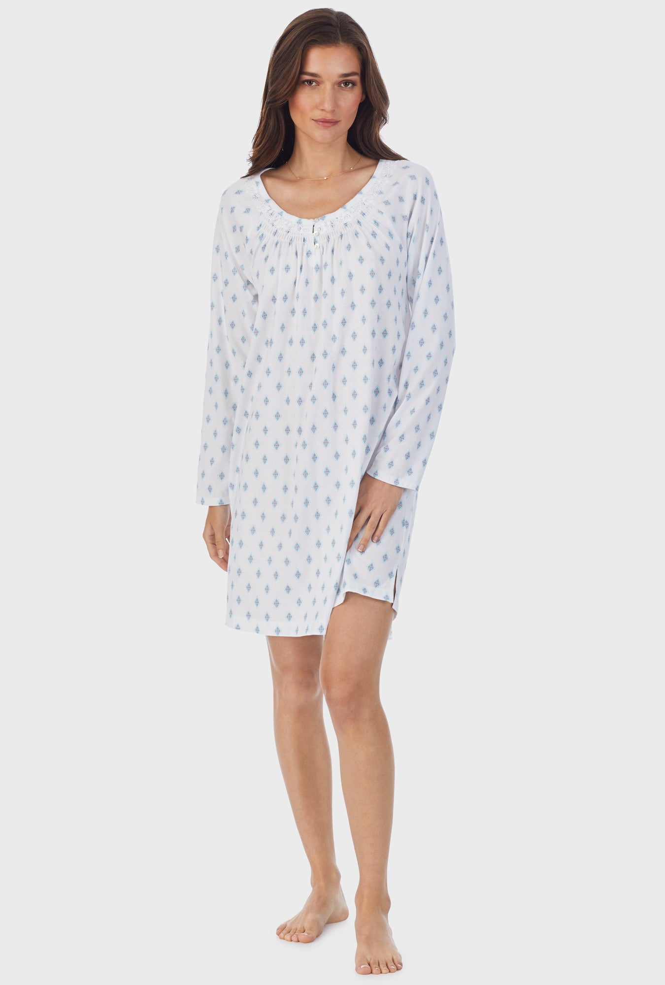 A lady wearing white long sleeve cotton short nightgown with aqua geo print.