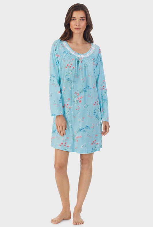 A lady wearing blue long sleeve cotton short nightgown with aqua floral.