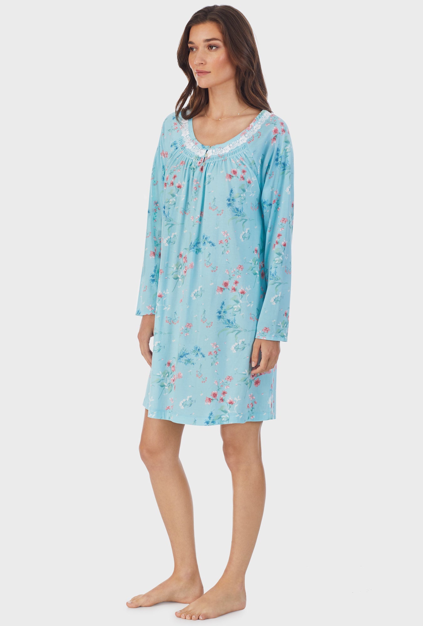 A lady wearing blue long sleeve cotton short nightgown with aqua floral.