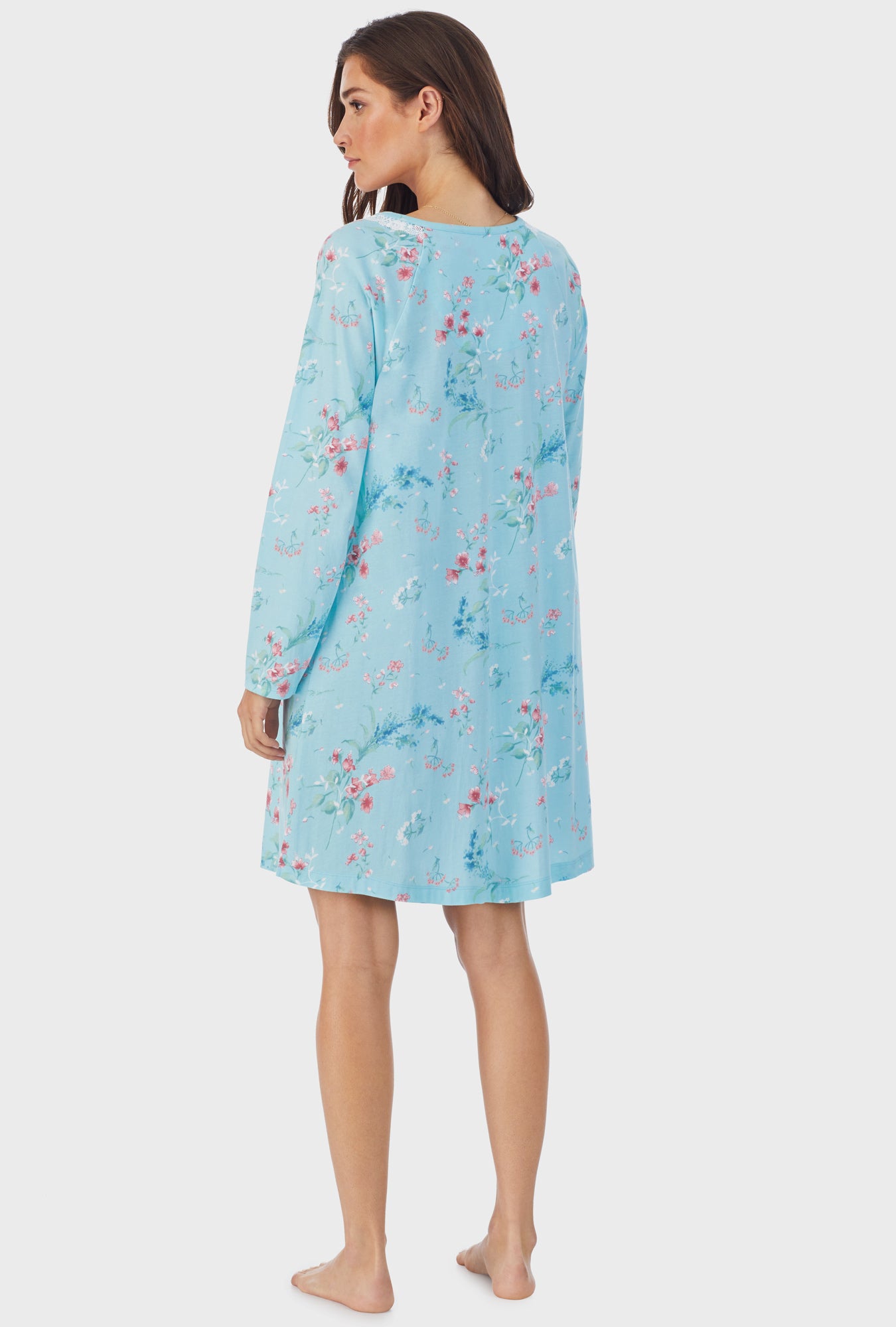 A lady wearing blue long sleeve cotton short nightgown with aqua floral.