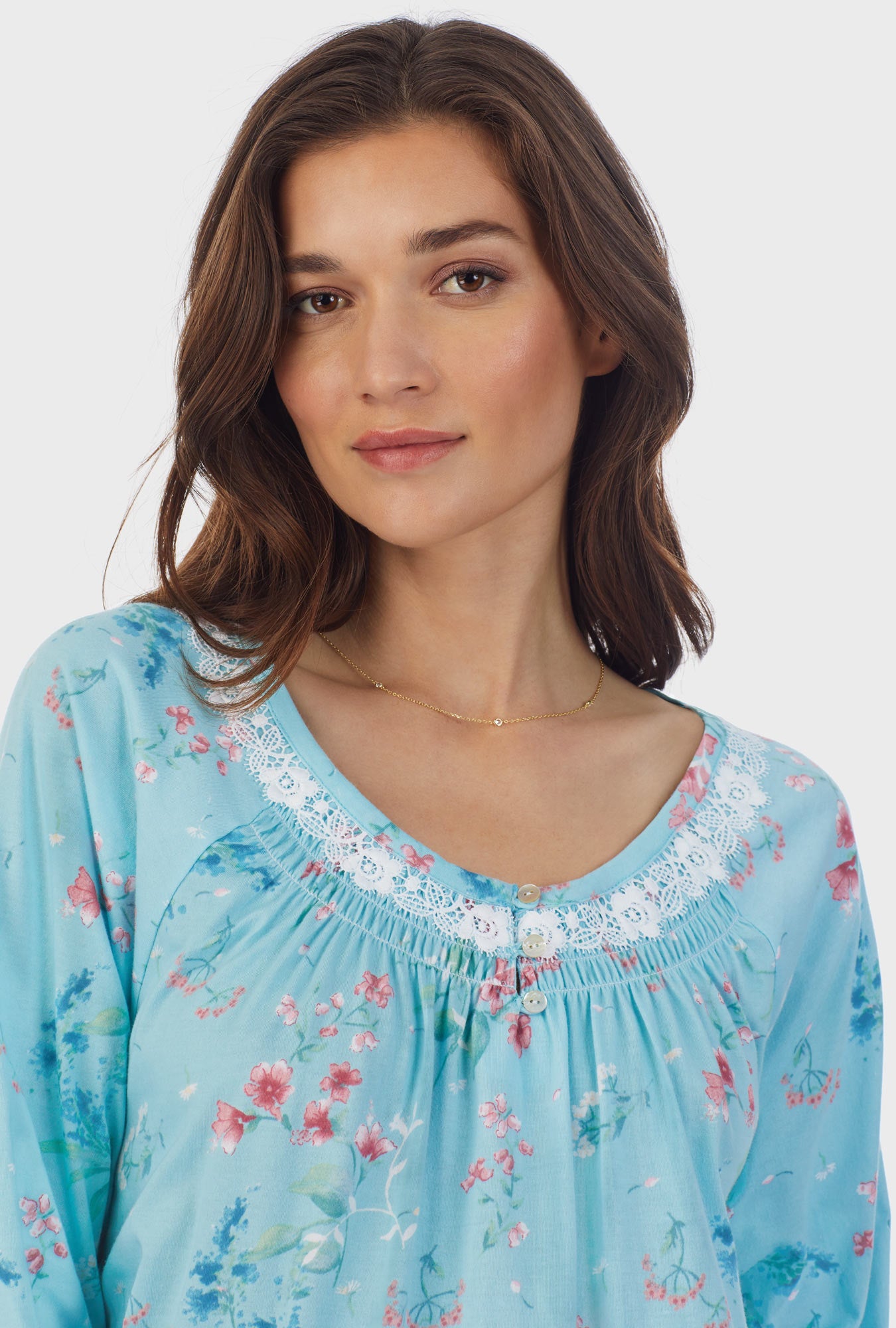 A lady wearing blue long sleeve cotton short nightgown with aqua floral.