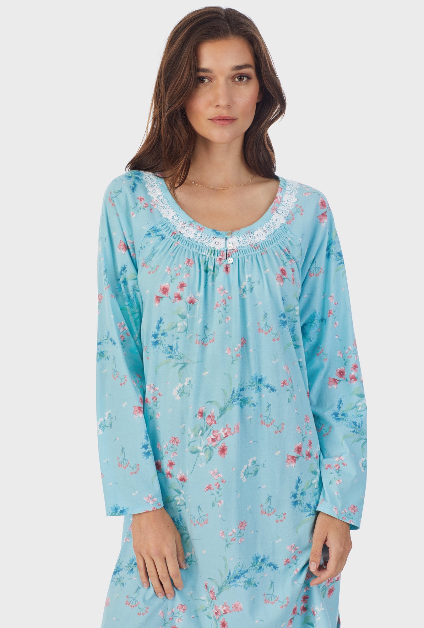 A lady wearing blue long sleeve cotton short nightgown with aqua floral.