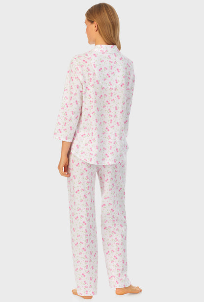 A lady wearing white quarter sleeve cotton long pajama set with blooming heart print.