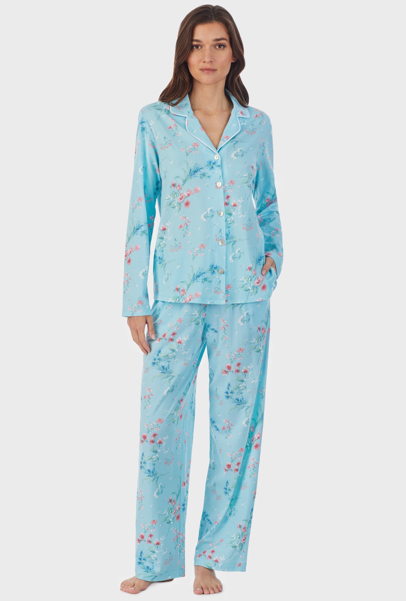 A lady wearing blue long pajama set with aqua floral print