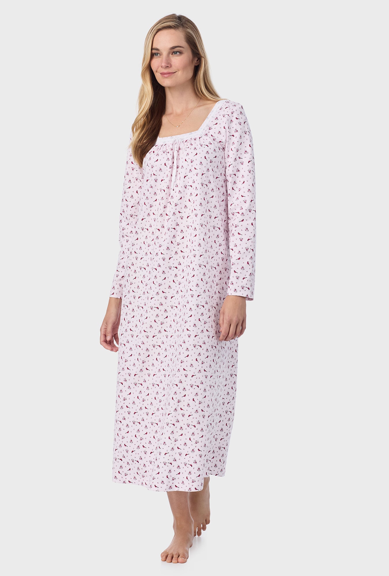 A lady wearing pink long sleeve cotton ballet nightgown with mini cardinal print.