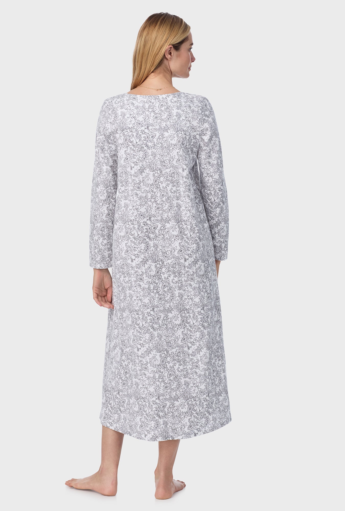 A lady wearing ballet nightgown with grey paisley print